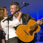 Republican U.s. Presidential Candidate And Minnesota Congresswoman Bachmann Embraces Singer Travis During A Performance At The Iowa Straw Poll In Ames