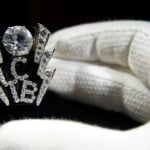 An Exhibition Staff Member Poses With Elvis' Tcb Ring, Tcb Is An Accronym For 