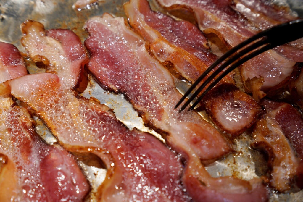 Photo Illustration Of Bacon Is Fried Up In A Pan In A Kitchen