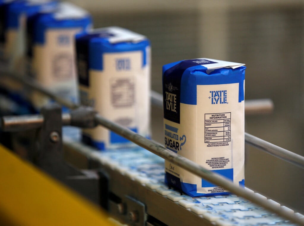 File Photo: Bags Of Granulated Sugar Move Along The Production Line At A Tate & Lyle Refinery In East London, Britain