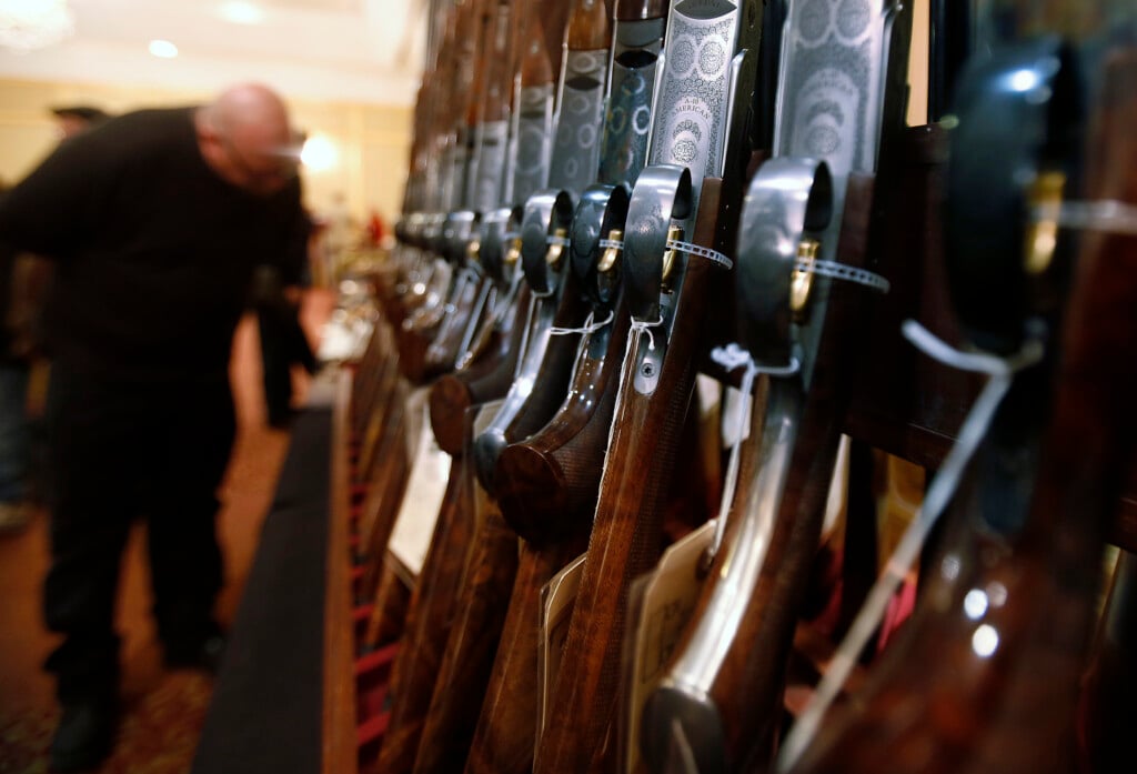 A Man Looks At A Shotgun During The East Coast Fine Arms Show In Stamford, Connecticut