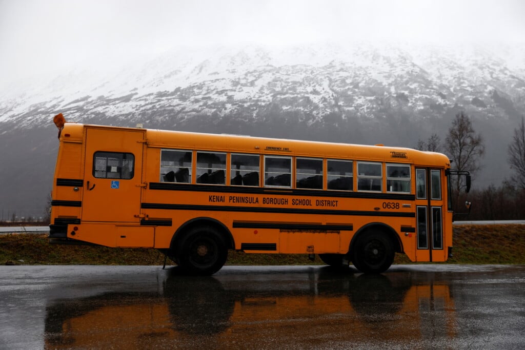 A School Bus Sits In A Parking Lot Of A Resort Town In The Chugach State Park During Heavy Rain In Girdwood, Alaska