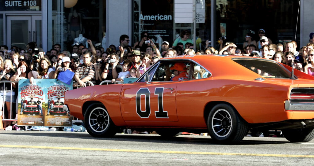 A 1969 Orange Dodge Charger Arrives At The Los Angeles Premiere Of "the Dukes Of Hazzard" In Hollywood.