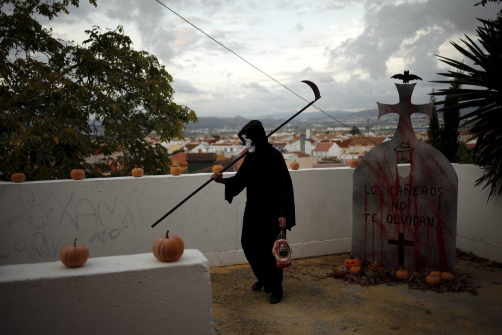 A Man Dressed As The Grim Reaper Walks During Halloween Celebrations In The Neighborhood Of Churriana, Near Malaga