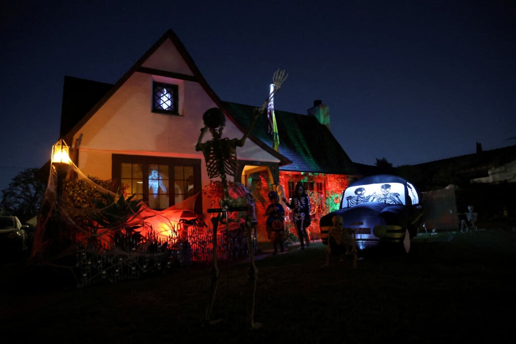 File Photo: Families Go Trick Or Treat By A Decorated House On Halloween Night In Pasadena