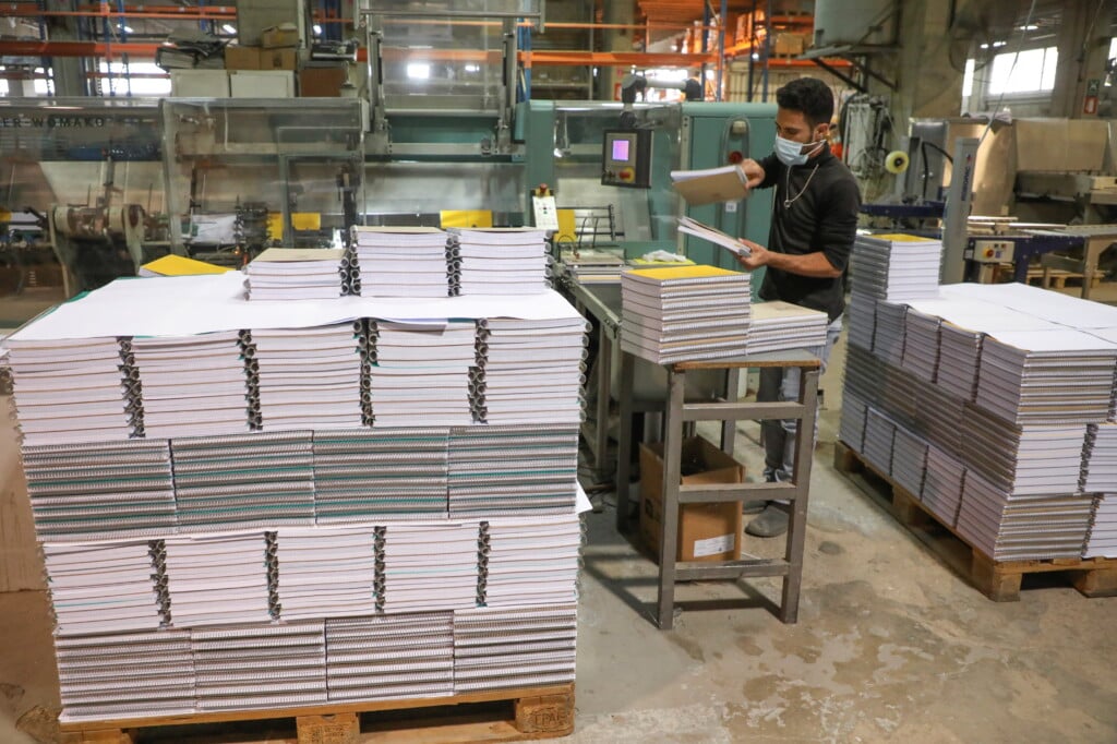 A Worker Arranges Notebooks At Oriental Paper Products, A Stationery Factory In Fanar