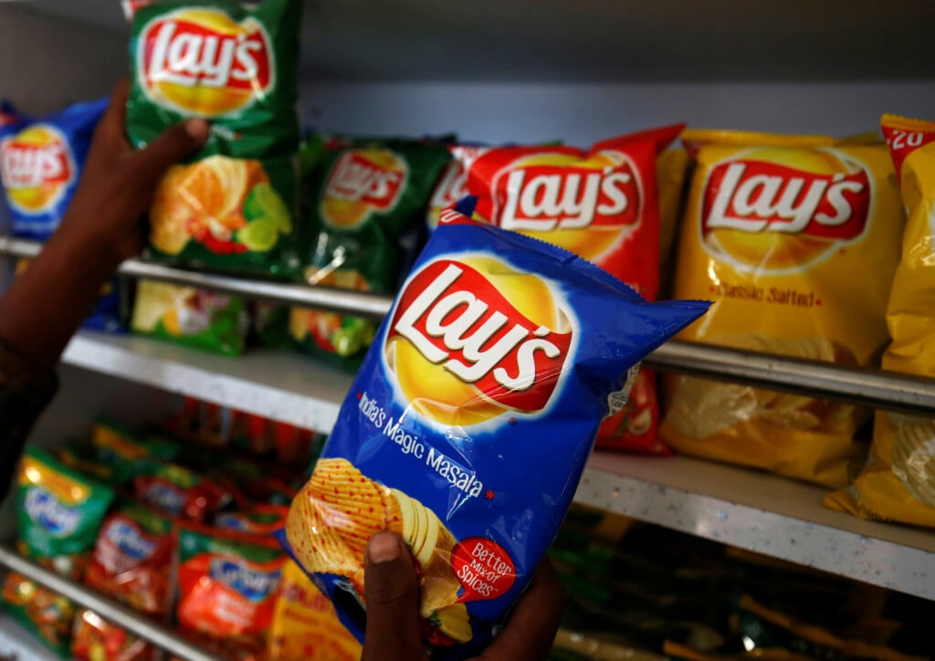 A Customer Picks Packets Of Lay's Potato Chips At A Shop In Ahmedabad
