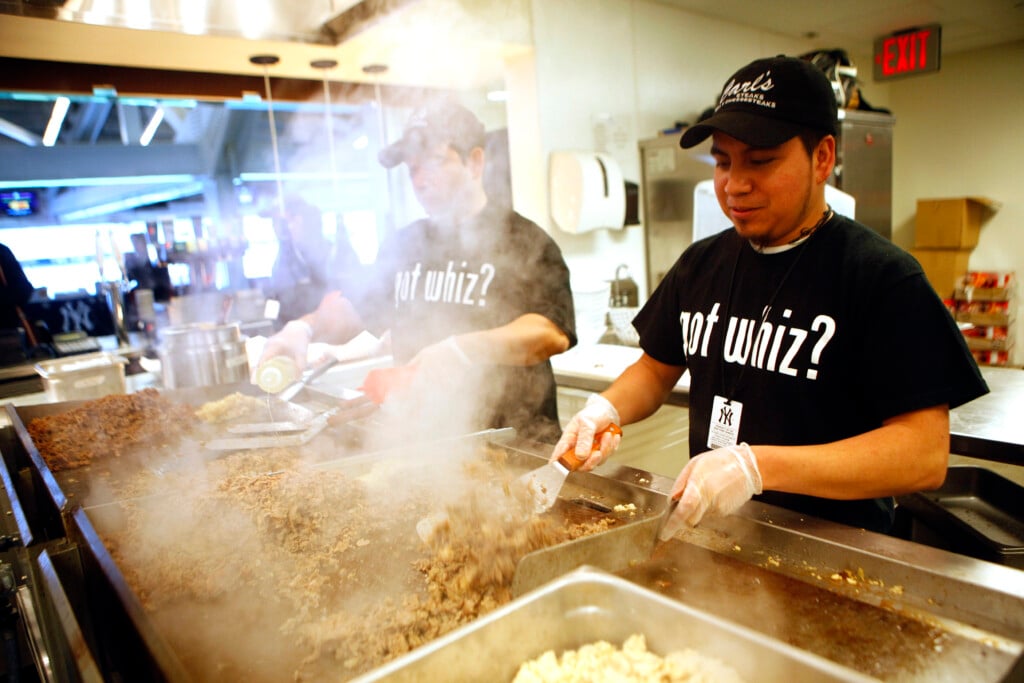Workers Cook Meat For Philly Cheesesteaks During A Media Food Tour At Yankee Stadium In New York