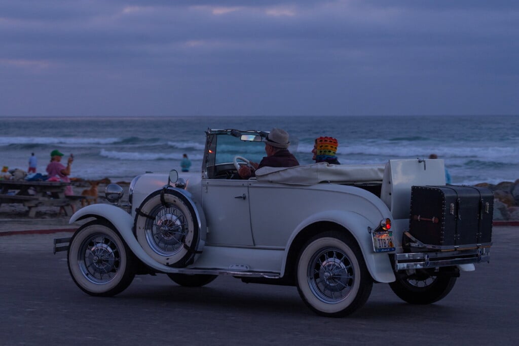 Elderly Couple In Antique Vehicle At The Beach In California