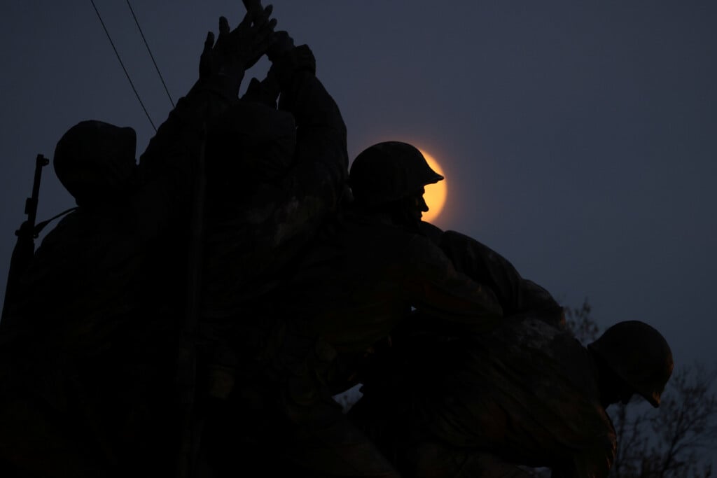 A Rising Supermoon Frames The Statue Of Soldiers In The U.s. Marine Corps War Memorial, Depicting The Wwii Flag Raising On Iwo Jima, In Arlington, Virginia