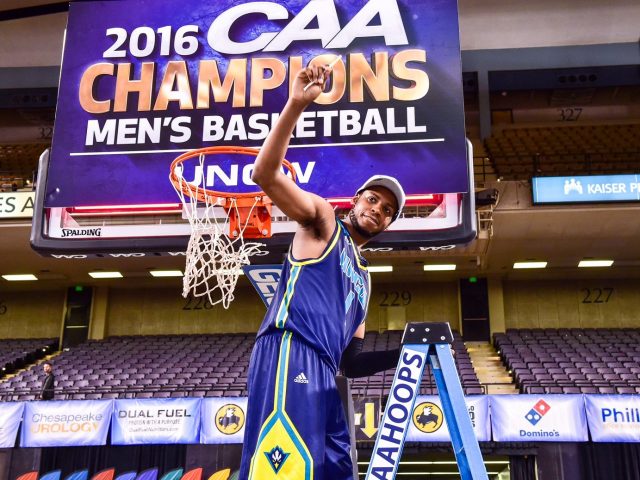 MAR 7, 2016: Baltimore, MD - Tournament MVP North Carolina-Wilmington Seahawks guard Chris Flemmings (1) cuts down the nets following their 80-73 overtime victory against Hofstra Pride during the CAA Basketball Finals at Royal Farms Arena in Baltimore, Maryland. (Photo: Philip Peters/Media Images International)