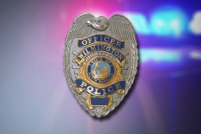 Wilmington Police Department badge over police lights