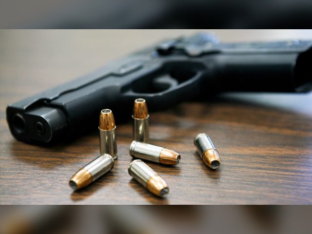 Gun on table with bullets