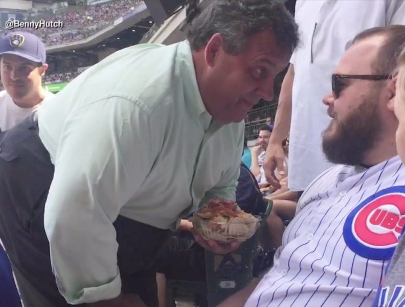 NJ Gov. Chris Christie confronts a man during a game between the Chicago Cubs and Milwaukee Brewers in Milwaukee on July 30