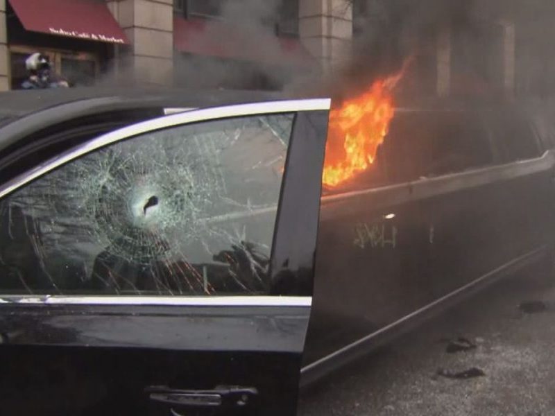 A limousine burns during riots in Washington