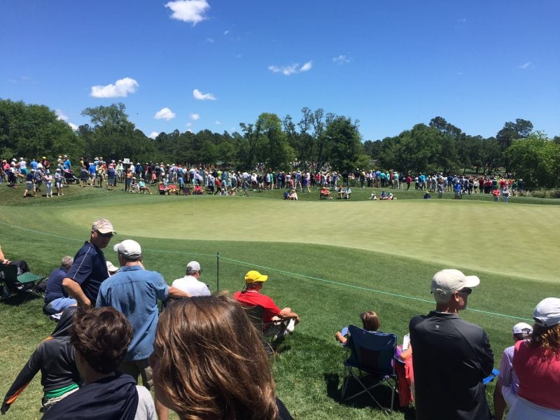 Fans line a green at the Wells Fargo Championship during the final round on May 7