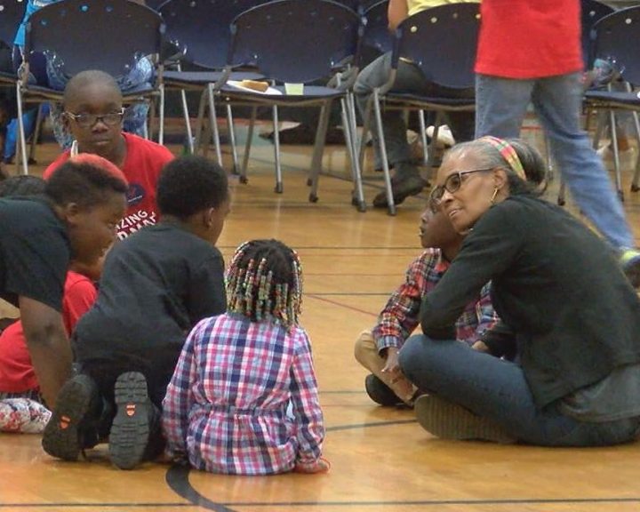 Bernadine Fulton sitting down with kids at the MLK center on May 13