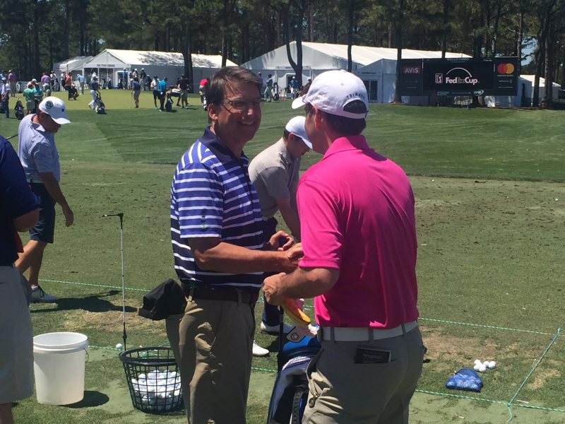 Pat McCrory chats on the driving range at the Wells Fargo Championship on May 3