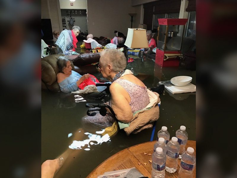 Residents of a nursing home sit in flood water as they wait to be rescued during Hurricane Harvey on Aug. 27