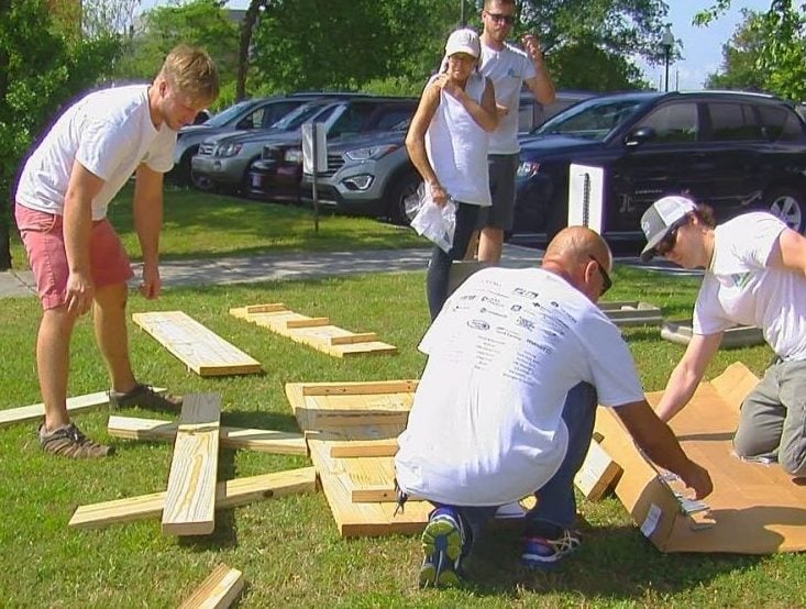 Volunteers working together on a picnic table at Work on Wilmington.