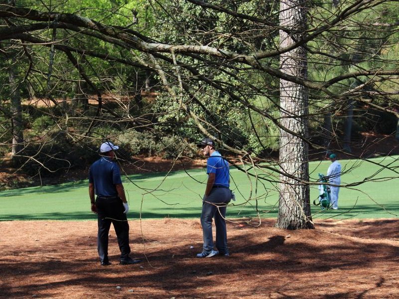 Phil Mickelson shows Masters rookie Jon Rahm the sight of his second shot o