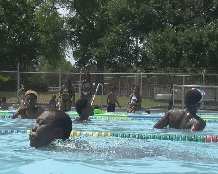 A group of kids enjoying the pool during a hot Memorial day on May 29