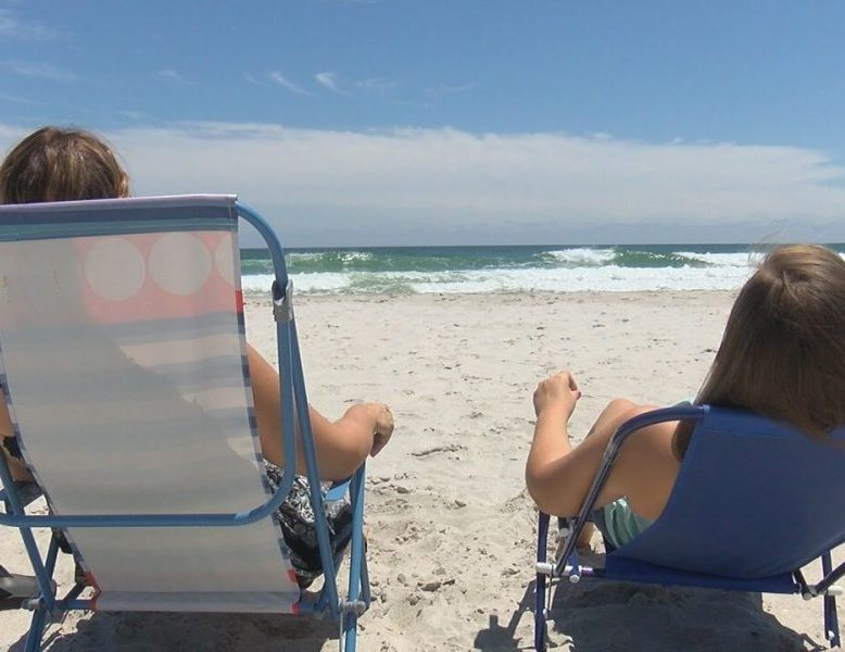 Jill Mellott sitting on the beach with her daughter on Topsail Island on July 31