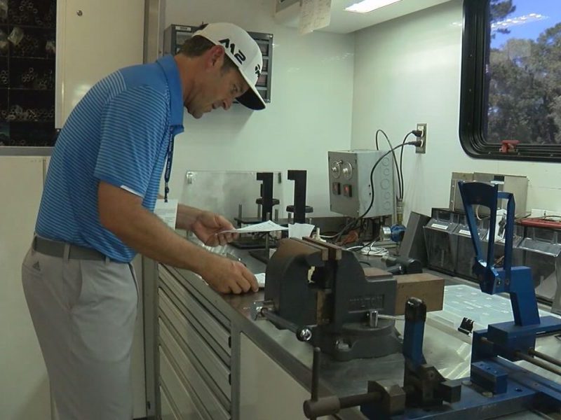 TaylorMade PGA Tour Manager Todd Chew works on clubs for players taking part in the Wells Fargo Championship on May 2