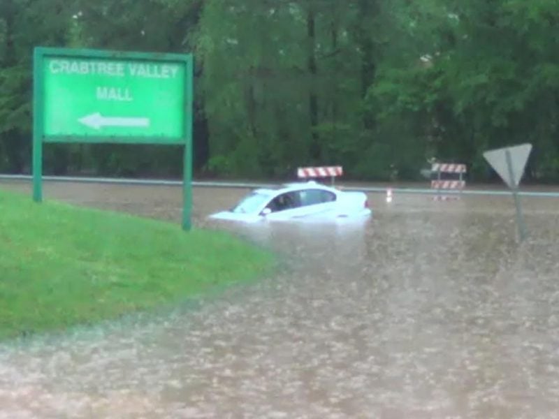 A car gets stuck in flood water near Crabtree Valley Mall in Raleigh on April 24