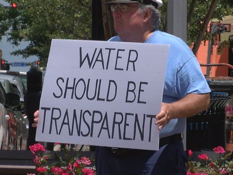 Protester holds sign at GenX protest at Wilmington City Hall on June 19