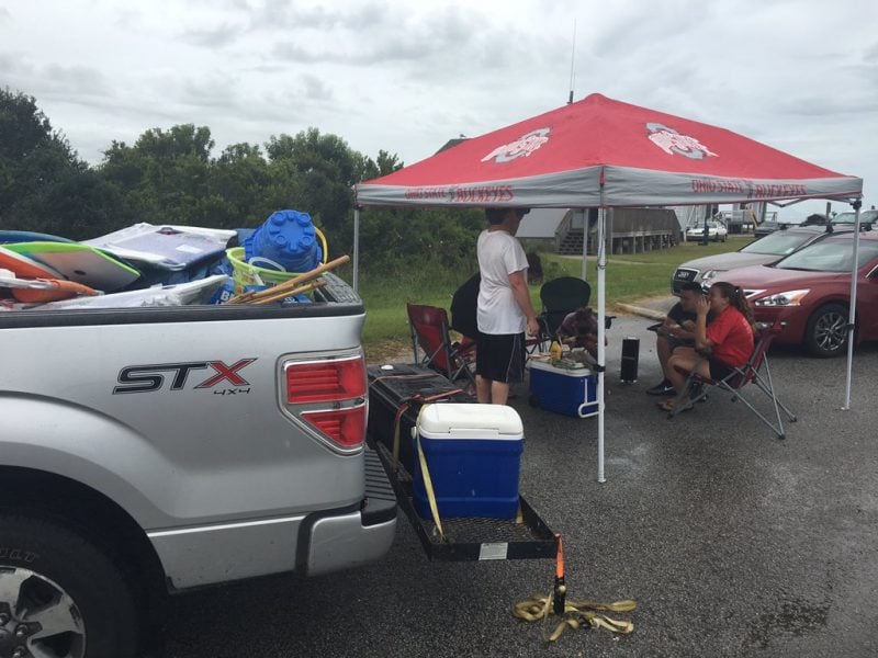 Visitors tailgate as they wait to get to Hatteras Island after it reopened following a week-long power outage on Aug