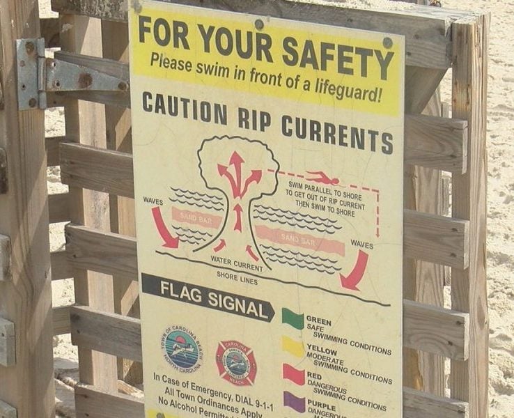 A sign on the beach in Carolina Beach letting visitors know of rip current safety on October 10