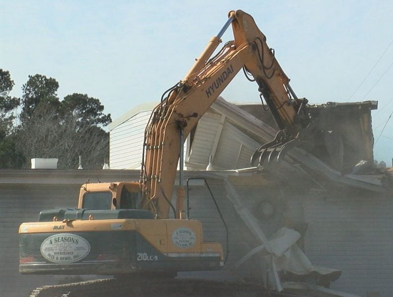 A construction vehicle beings demolition on the old National Guard building on December 12