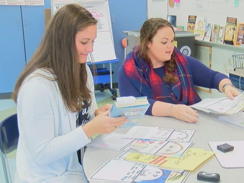 Kirbe Northam and Kelsey Frantz looking over an assignment the kids did in relation to "Wonder" on November 14