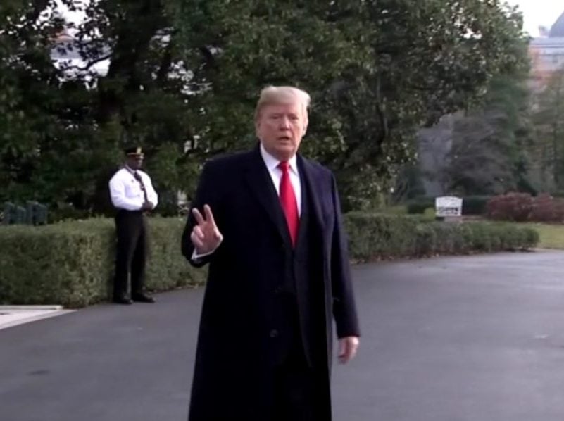 President Donald Trump stops to talk with reporters as he heads to Marine One at the White House on Dec. 4
