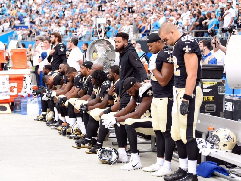 New Orleans Saints players sit in down during national anthem. (Photo: Ed Clemente / MGN)