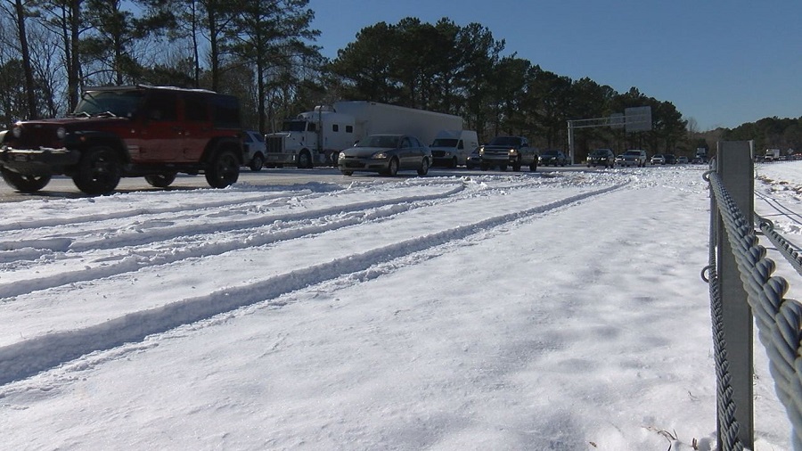 Cars and trucks were moving slowly along Highway 74 on the way to Wilmington due to a sheet of ice on the road on January 5