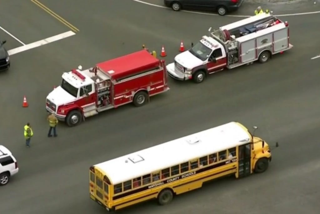 A school bus takes students away from Marshall County High School in Kentucky after a shooting killed one student and hurt nine others on Jan. 23