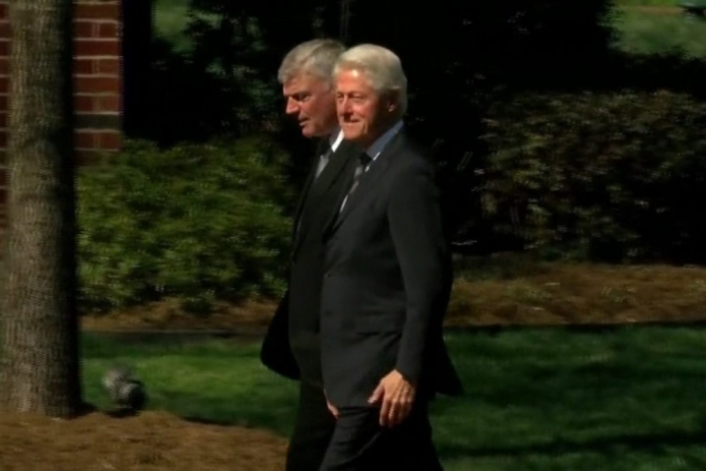 Former President Bill Clinton walks with Franklin Graham at the Billy Graham Library in Charlotte on Feb. 27