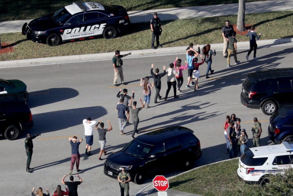 Students and staff are led out of Stoneman Douglas High School in Parkland