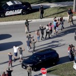 Students and staff are led out of Stoneman Douglas High School in Parkland
