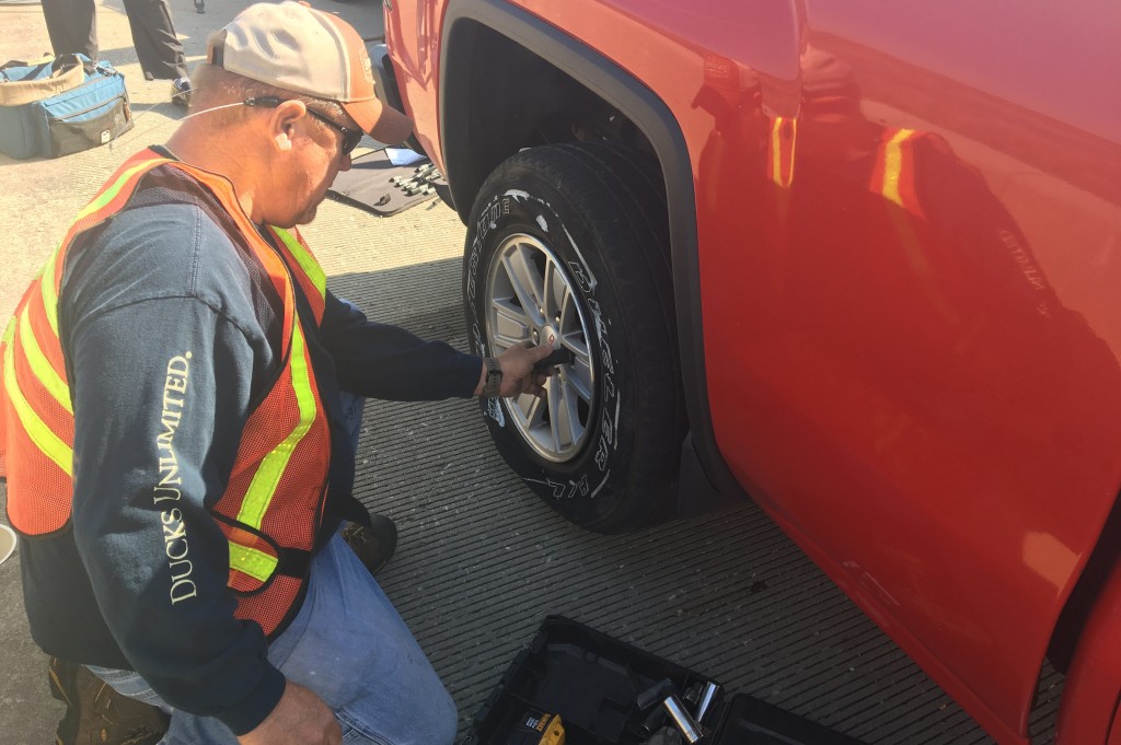A tow truck driver removes a flat tire on I-140 in New Hanover County on March 16
