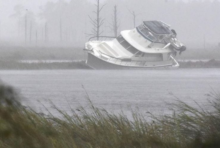 A boat washed into the marsh along Smith Creek.