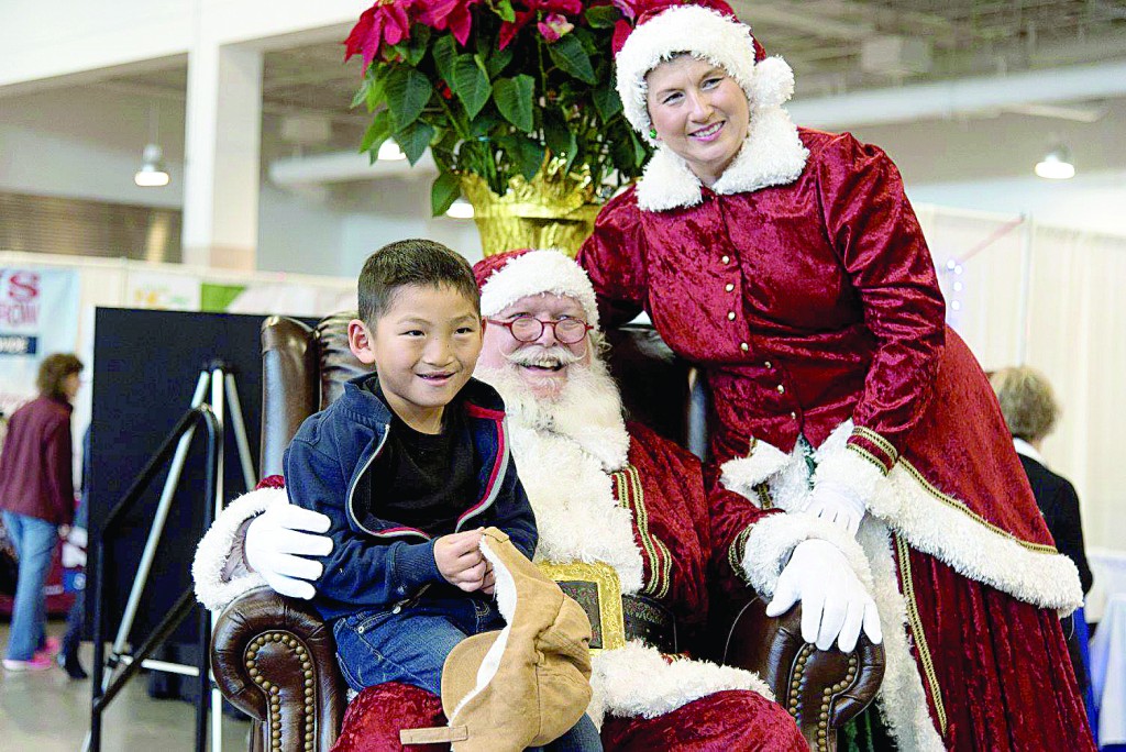 A child visits with Santa at the WILMA Expo and Holiday Market