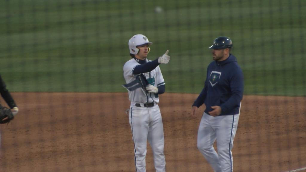 Brock wills celebrates a single with a thumbs up to the dugout