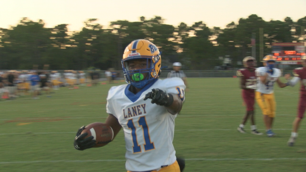 Tyjhere Crudup holds the football after making a touchdown and points towards the camera