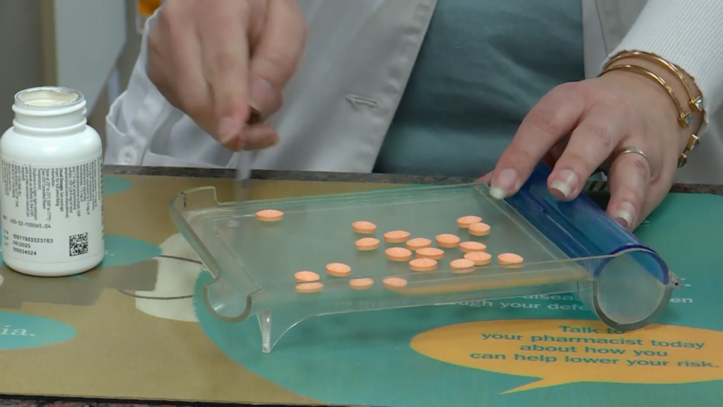 A pharmacist fills a prescription.