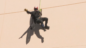 A volunteer dressed as Batman performs stunts for hospital patients.