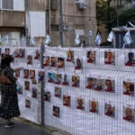 A woman looks at photographs of hostages who were abducted during the October 7th Hamas attack on Israel.