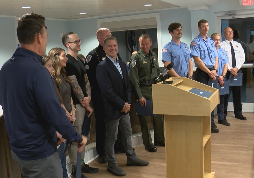 Ben Tracy stands with citizens and public safety professionals who saved his life on October 20th.
